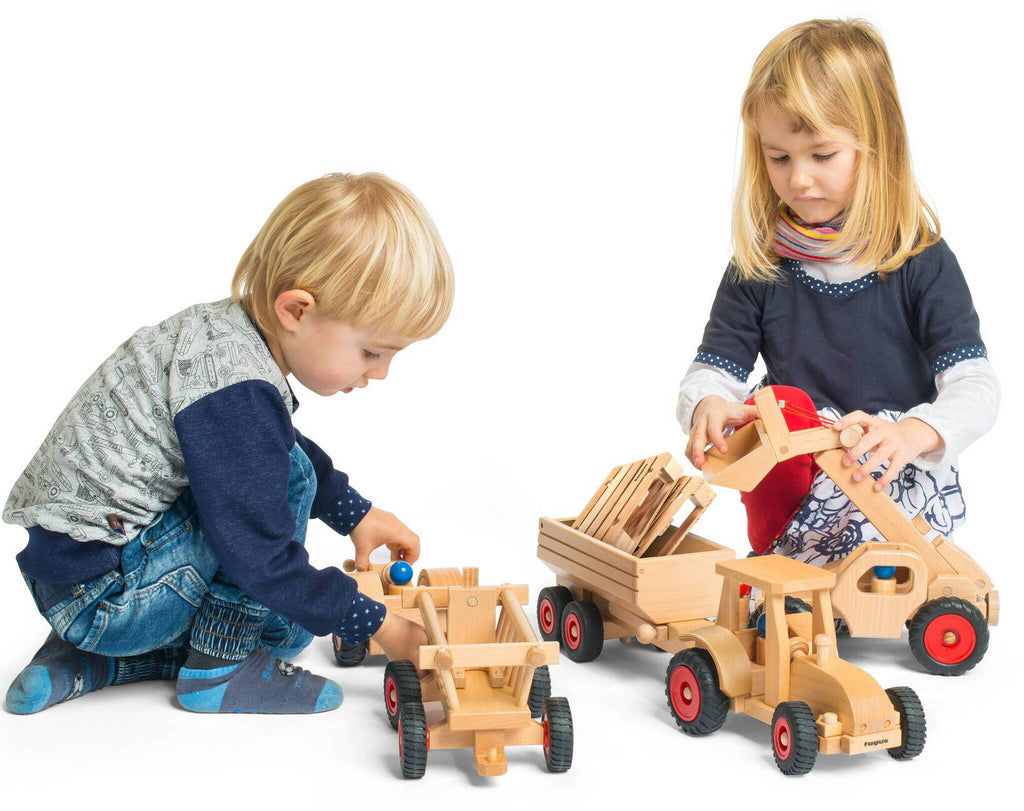 Kinder mit Holzfahrzeugen